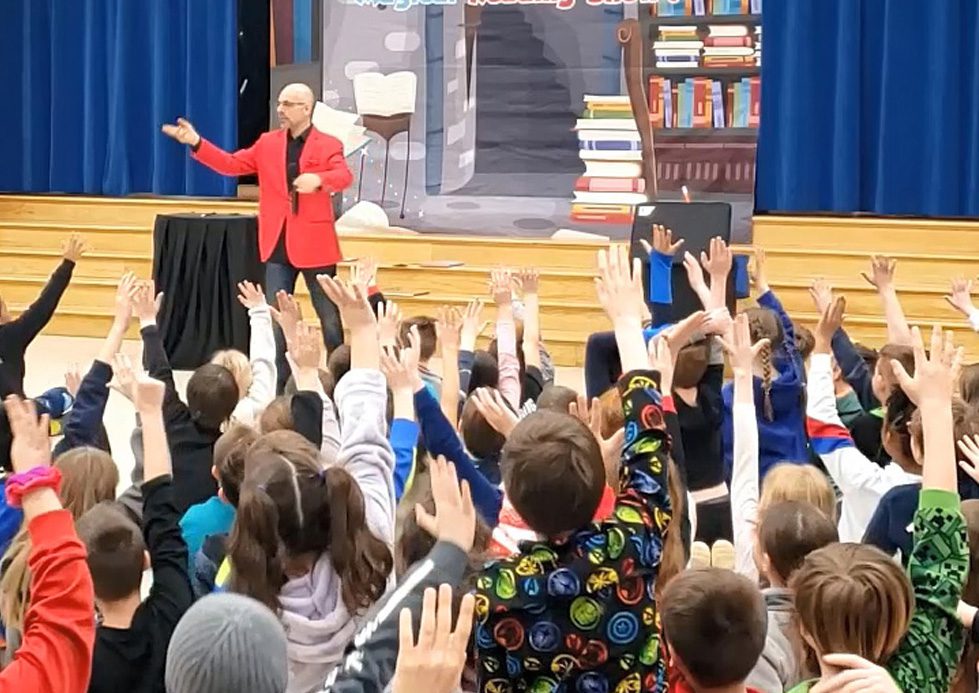 School assembly magic show with kids laughing